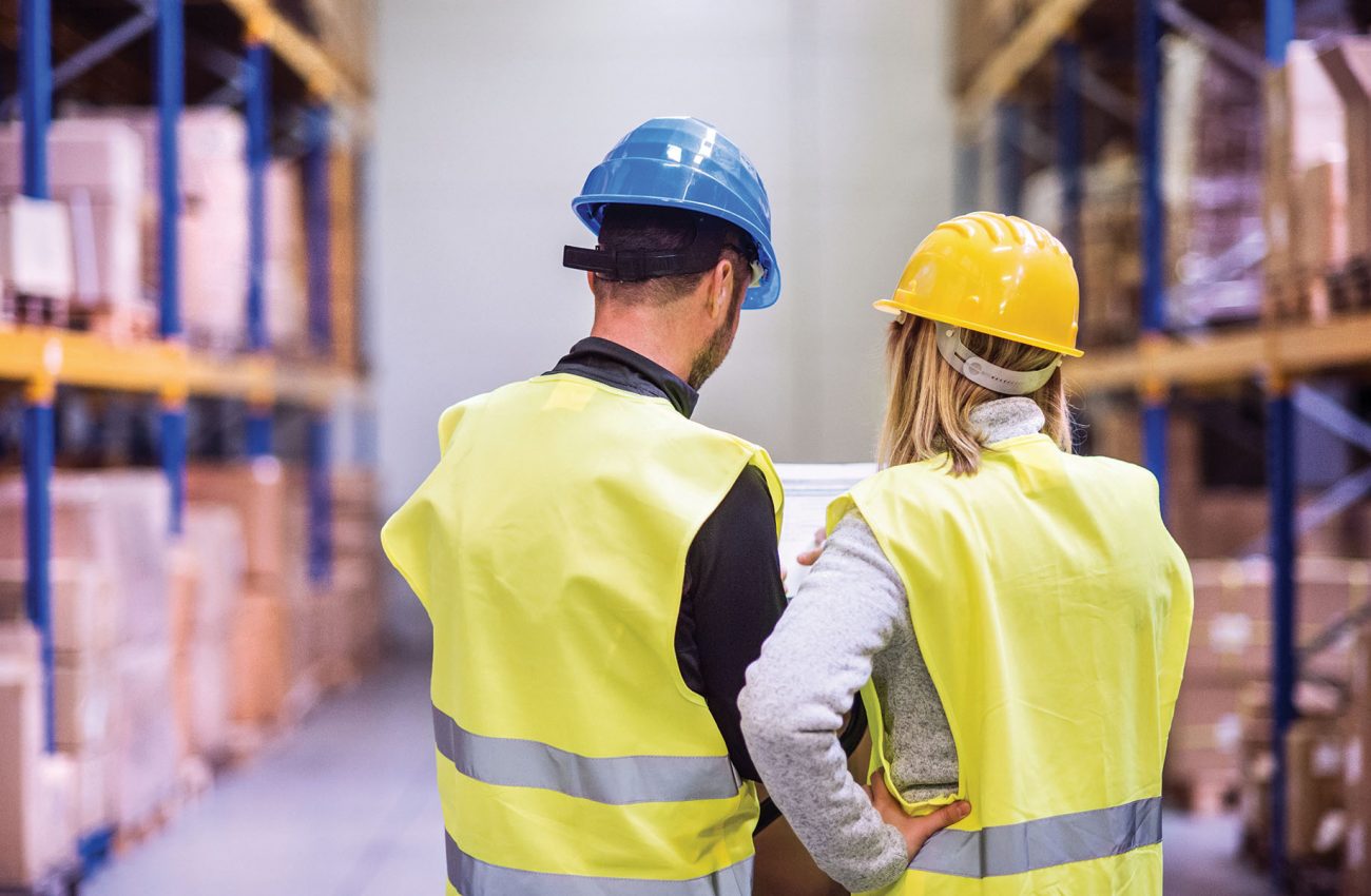 Young warehouse workers working together.