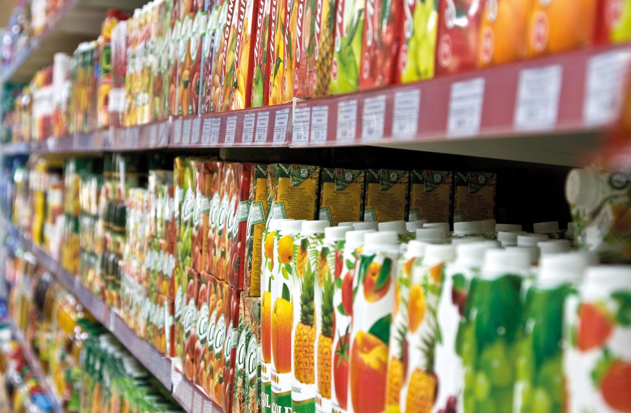 Shelves with fruit juices in boxes in a supermarket