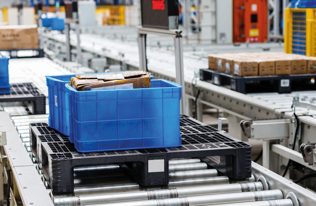 Packed courier on production line against cardboard boxes in war