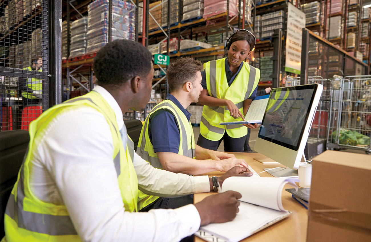 Team discussing warehouse logistics in an on site office