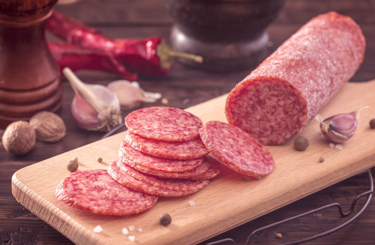 Sliced salami on board