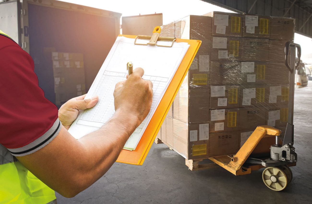 Worker Holding Clipboard and Writing on Paper. Ckecking Order Pa